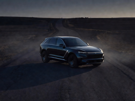 Dark luxury SUV parked on a deserted road